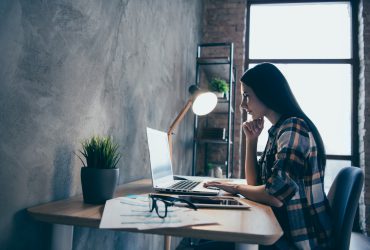 Profile side view of her she nice lovely charming attractive executive manager brunette lady checked shirt preparing marketing review report at industrial loft style interior room work place station.