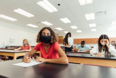 High school students and teenagers go back to school in the classroom at their high school. They are required to wear face masks and practice social distancing during the COVID-19 pandemic. They value their education and are excited to be in school. Image taken in Utah, USA.